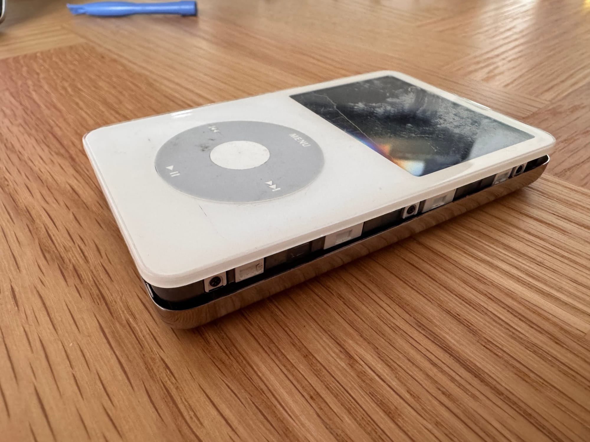 An iPod classic with the two halves just slightly separated.