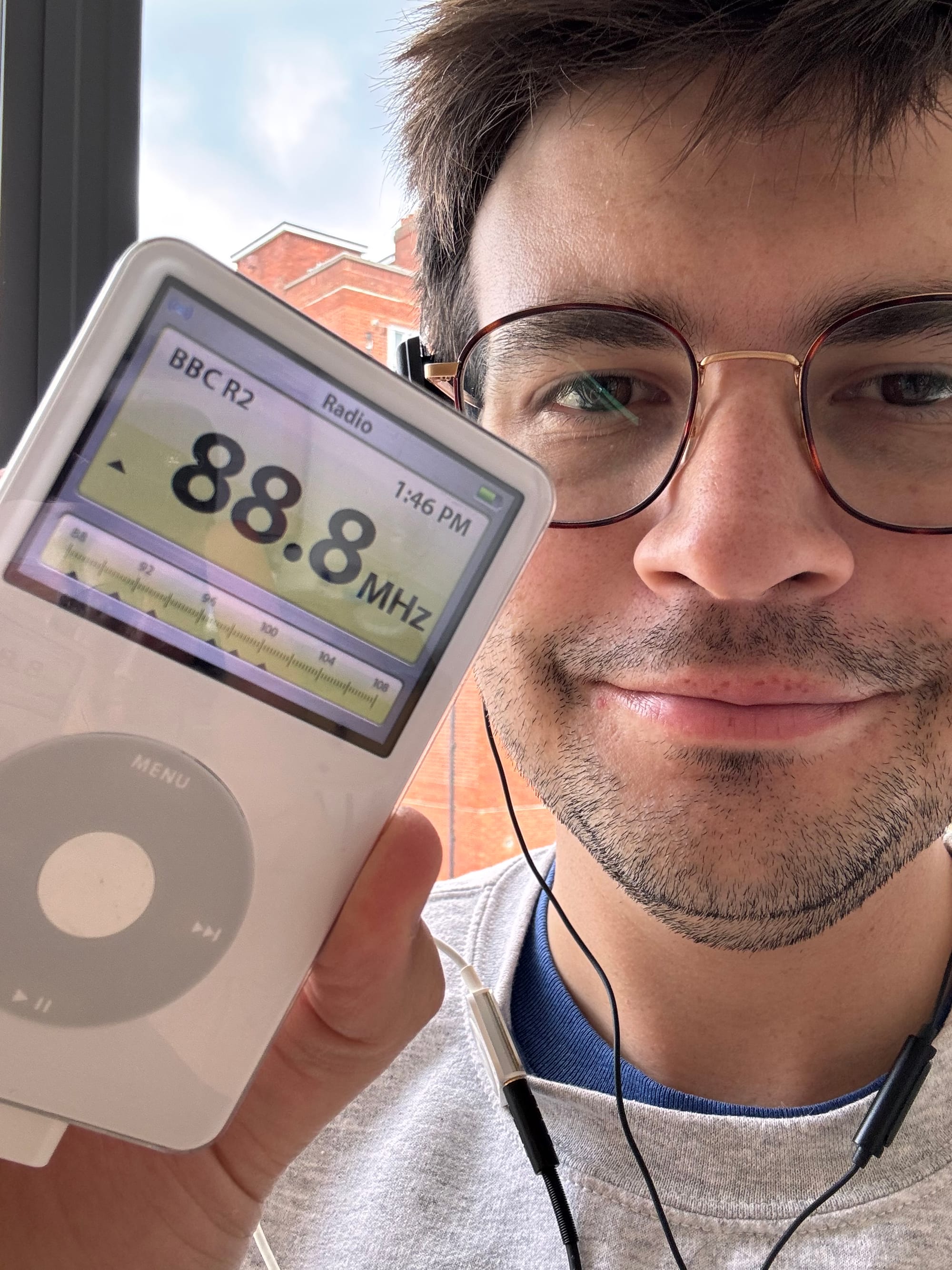 The author holding an iPod tuned to BBC Radio 2 on 88.8 FM.