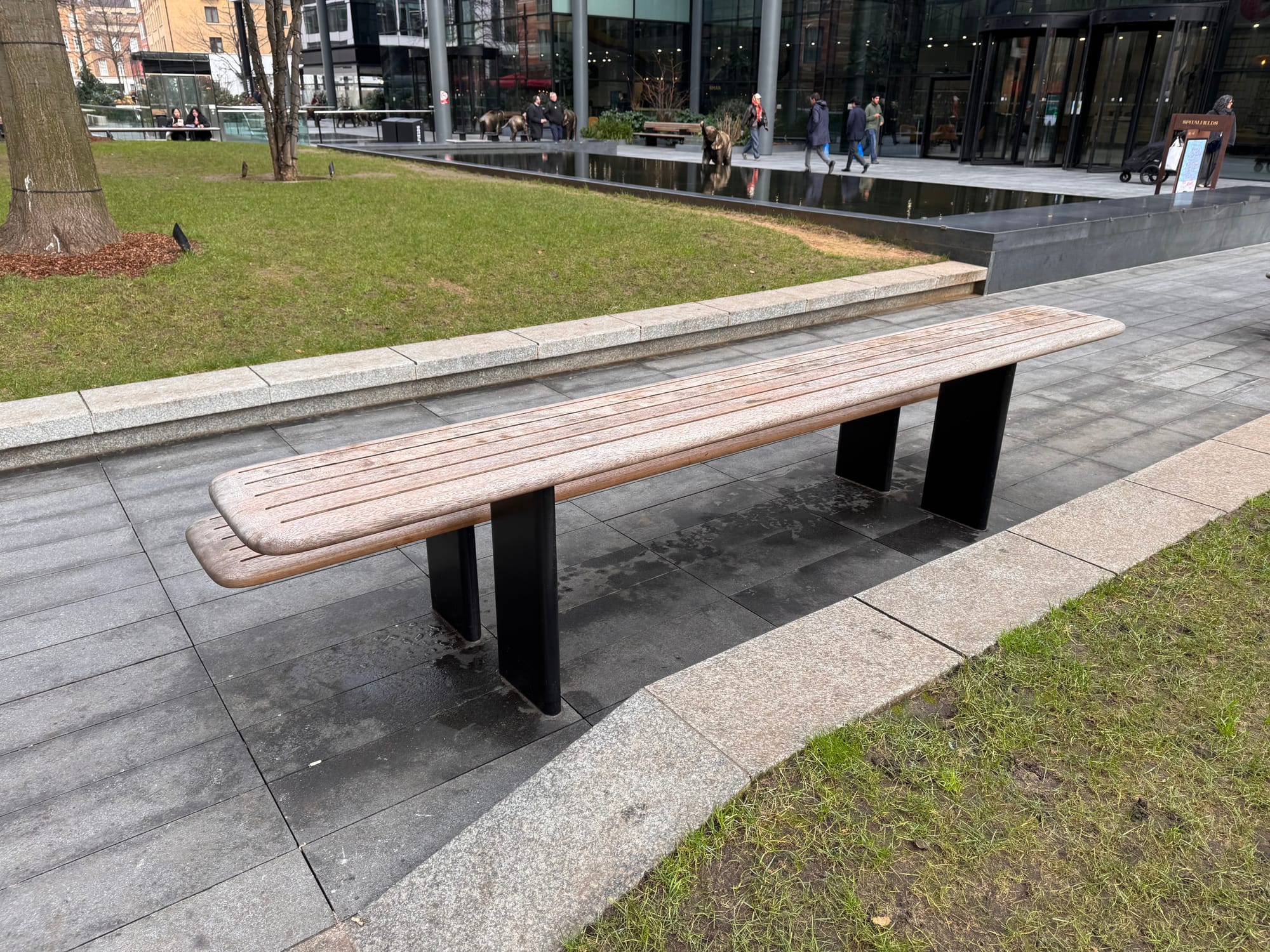 A long bench with a second tier above it and offset to act as a sort of table.