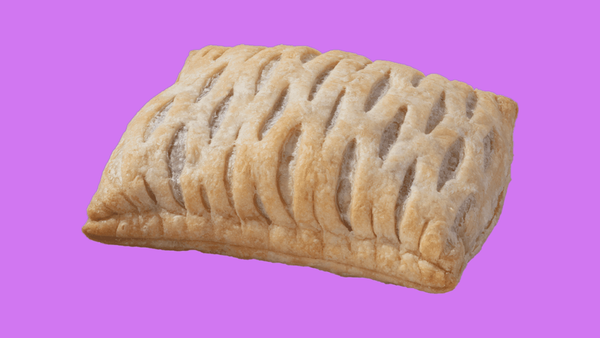 A Greggs Vegan Festive Bake on a purple background (Night Water brand color).